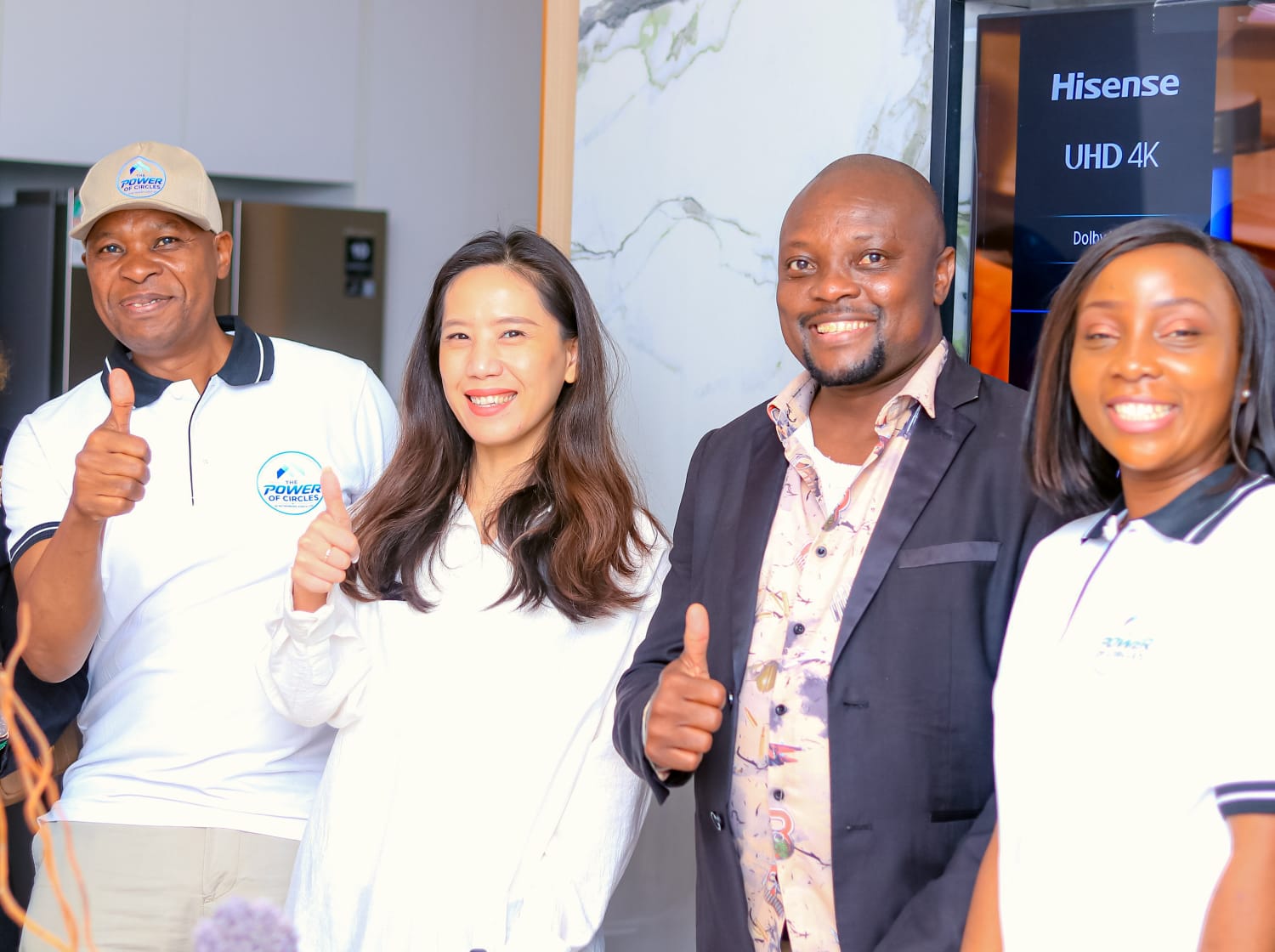 Partners giving a thumbs up at a property showcase event
