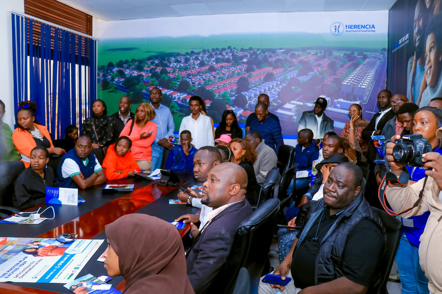 Delegates gathered around the table during a Herencia project presentation